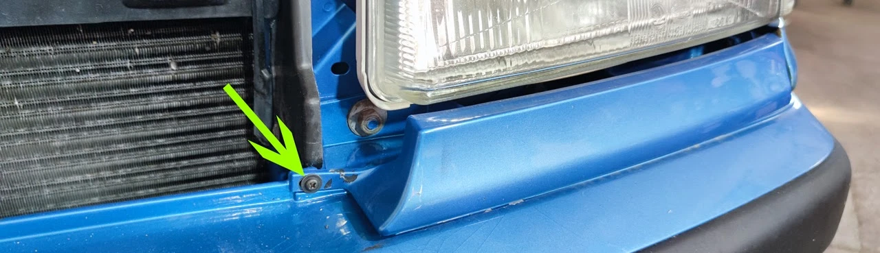Screw on the trim strip below the headlight
