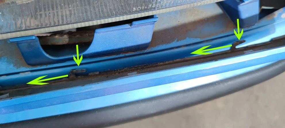 Removing the trim strip by sliding it towards the radiator