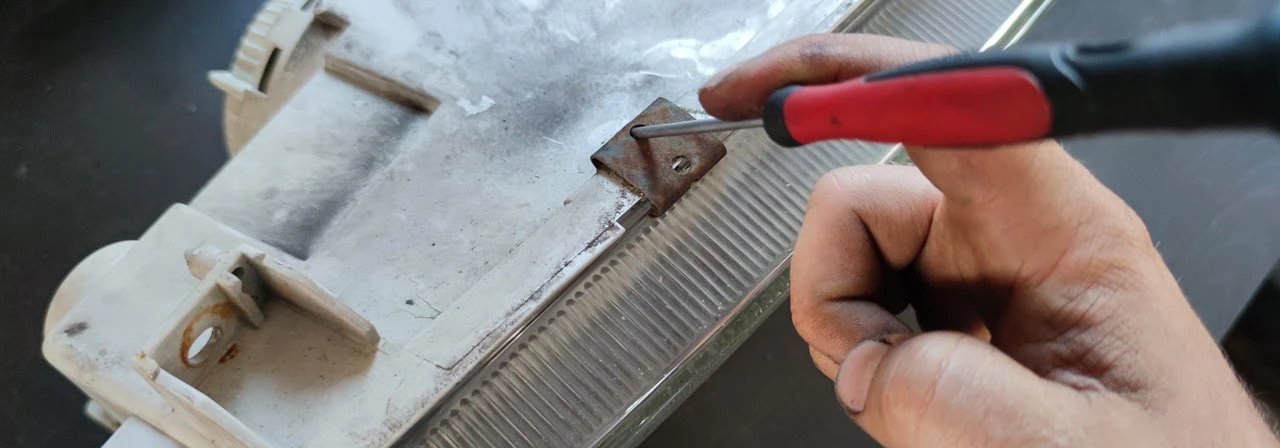 Prying a clip out with a screwdriver